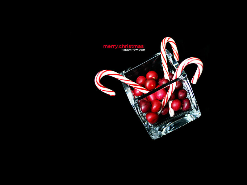 Candy canes and cranberries in glass