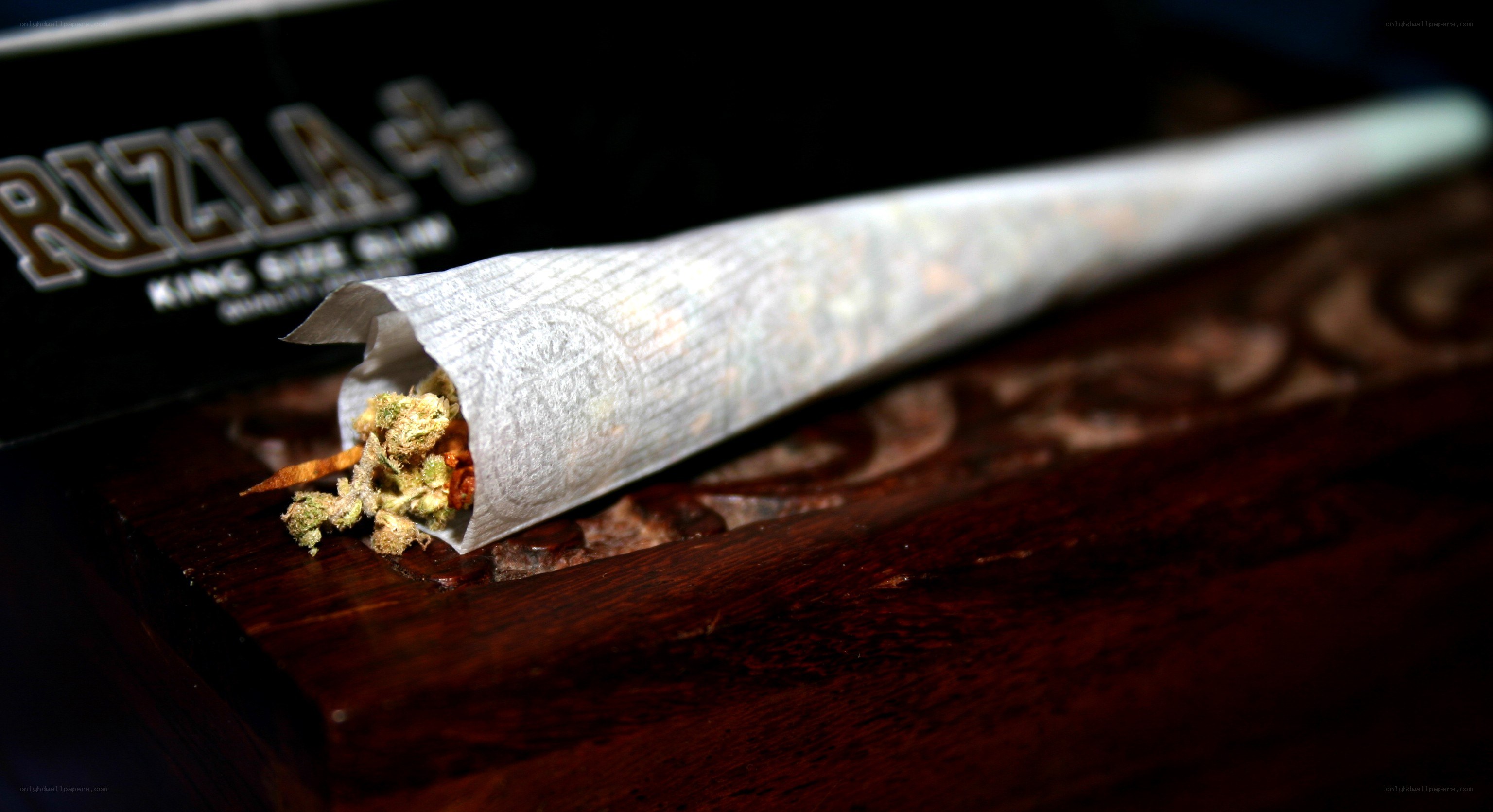 cannabis joint on wooden surface