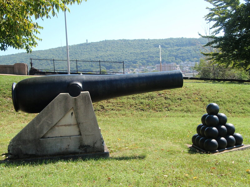 Cannon and cannonballs on a hill