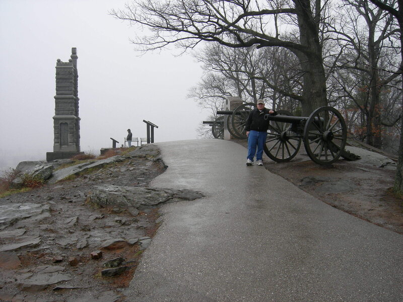 Cannon and monument on a foggy hill