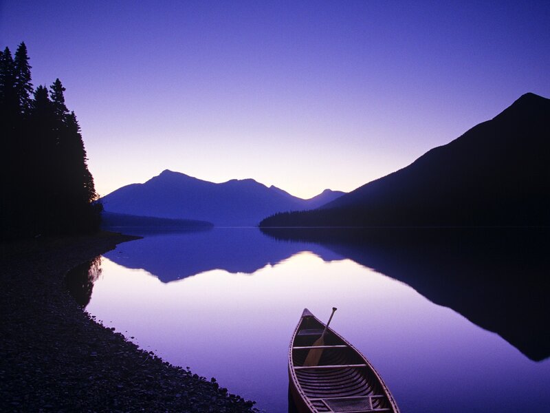 Canoe at dawn on a calm lake