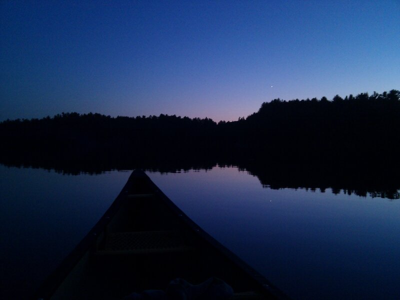 Canoe at dusk on a calm lake