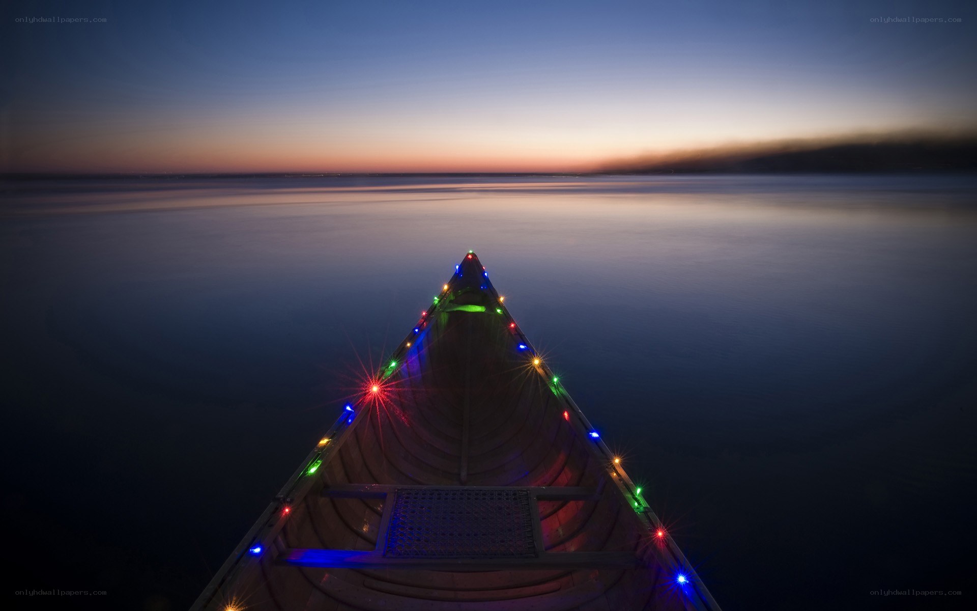 canoe at dusk with lights
