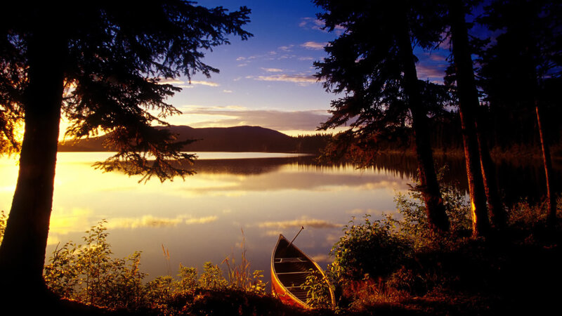 Canoe at sunset on a calm lake