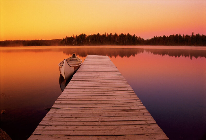 Canoe at sunset on a calm lake
