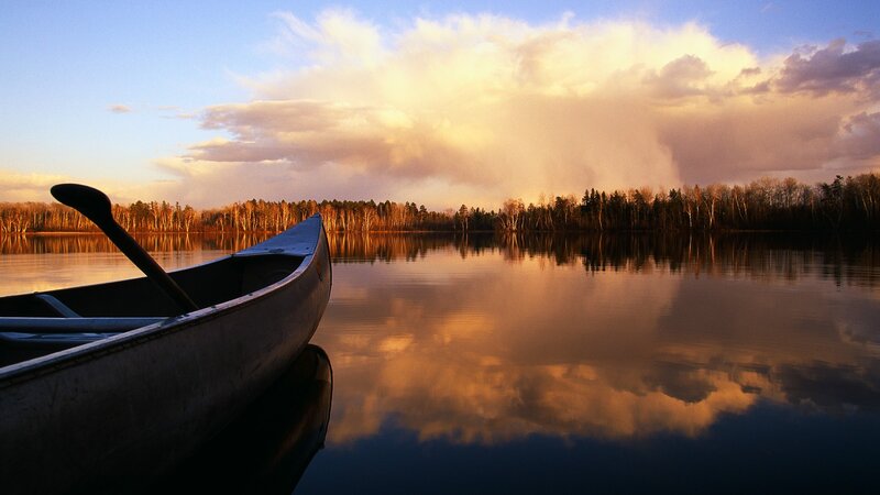 Canoe at sunset on a calm lake