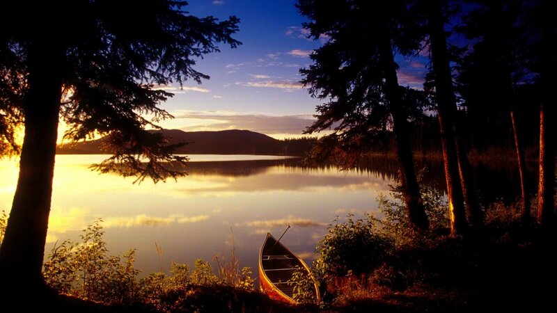 Canoe at sunset on a calm lake