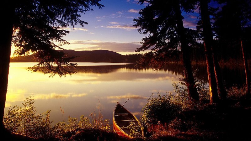 Canoe at sunset on a calm lake