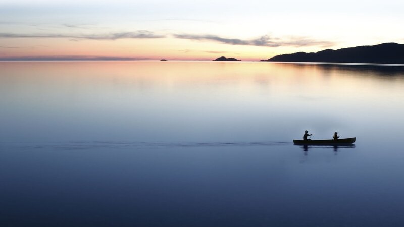 Canoe at sunset on calm water