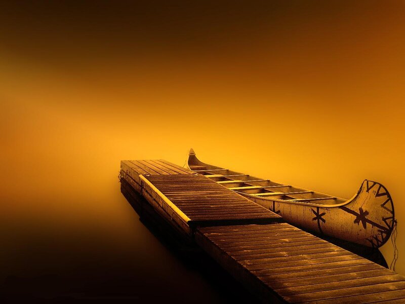 Canoe at sunset on calm water