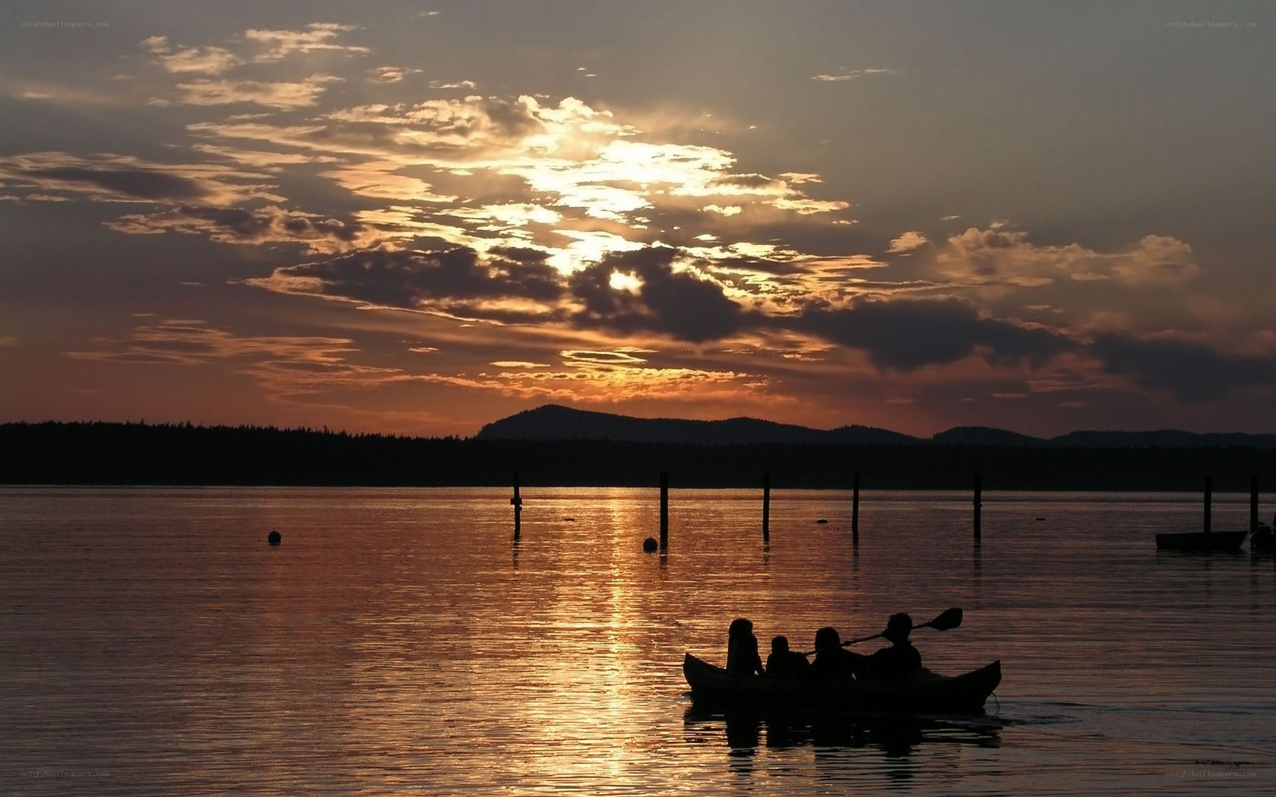 Canoe at sunset on calm water