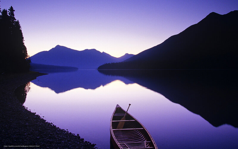 Canoe on a calm lake at dusk