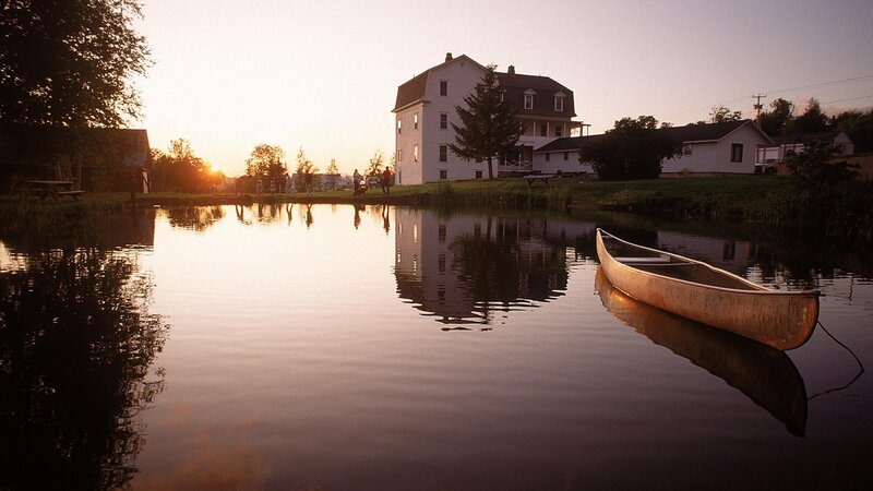 Canoe on a calm lake at sunset