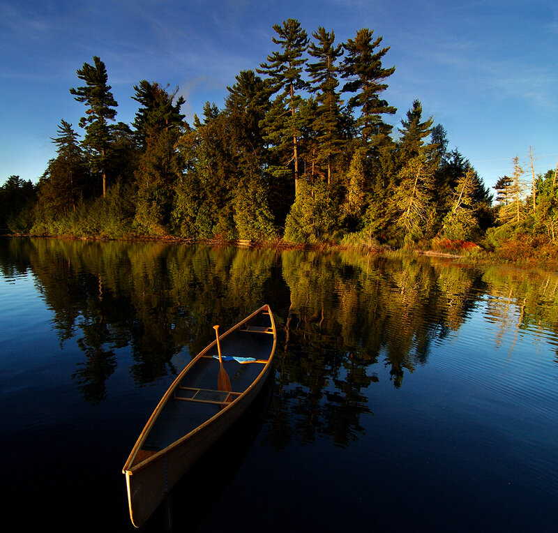 Canoe on a Lake — Blue, Serene, Sunset