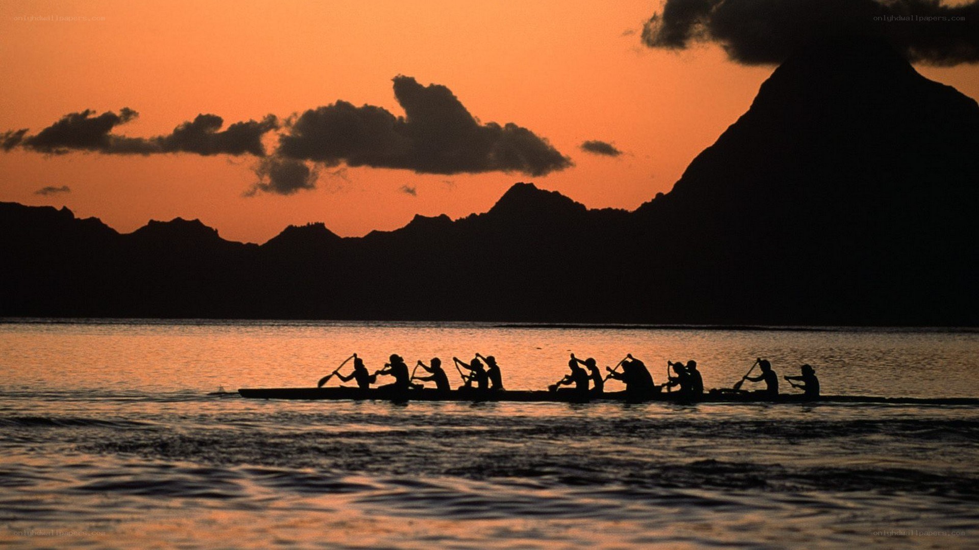 Canoe paddlers at sunset