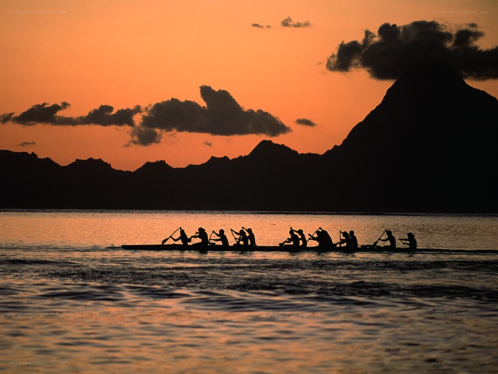 Canoe paddlers at sunset