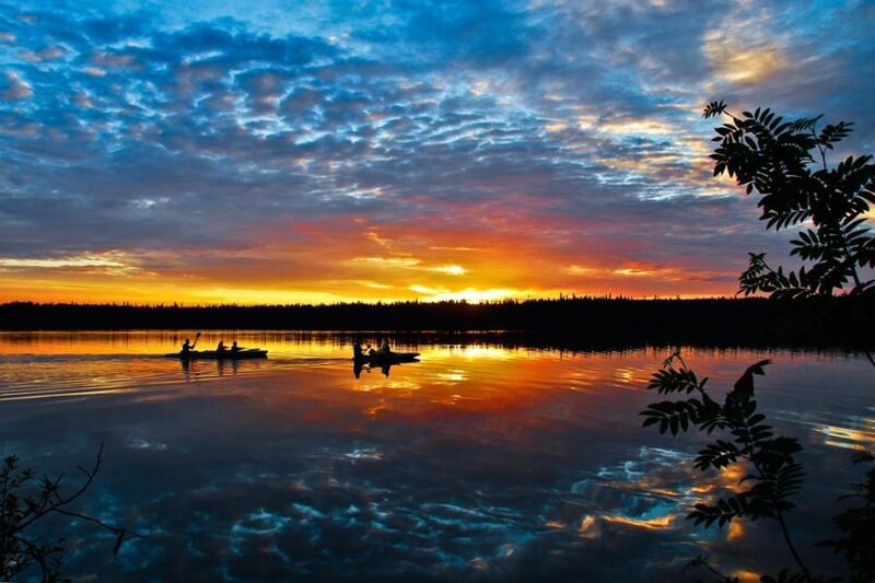Canoeing at sunset on a calm lake