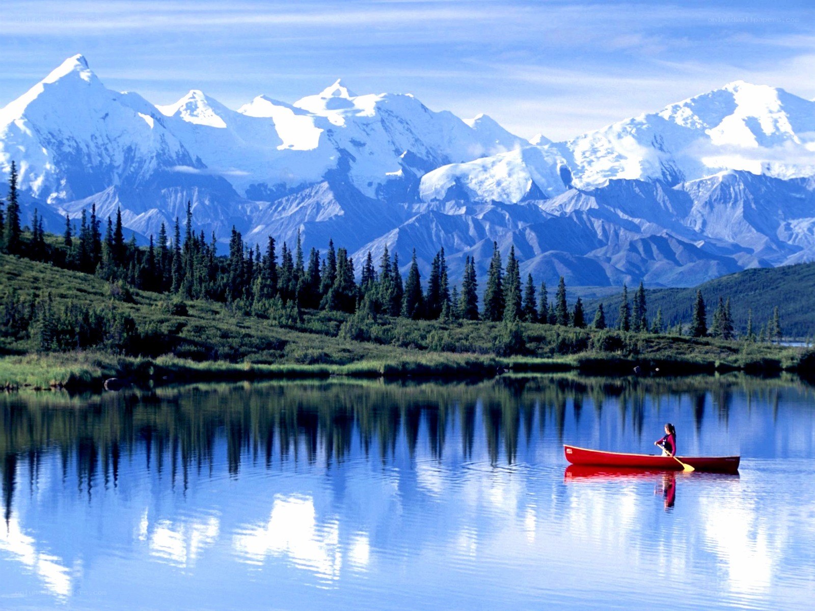 Canoeing near snow-capped mountains