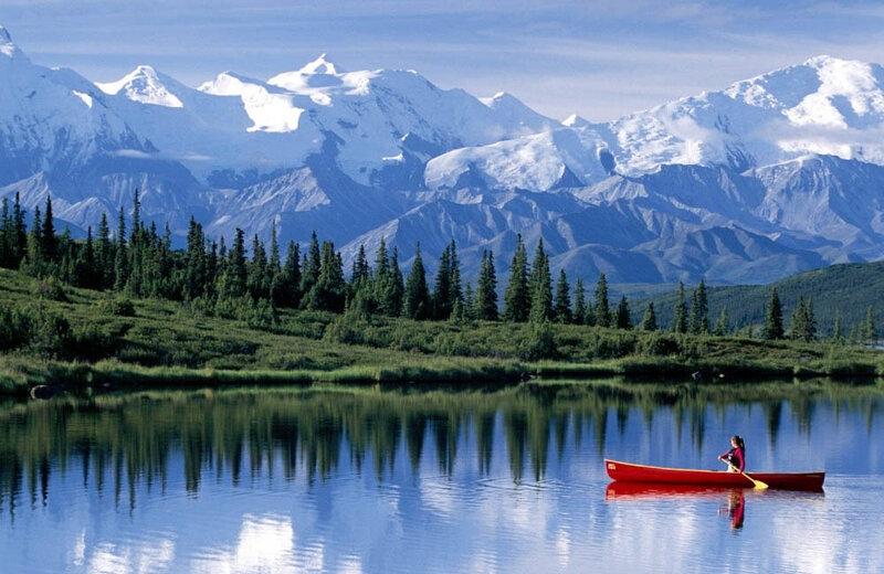 Canoeing near snow-capped mountains