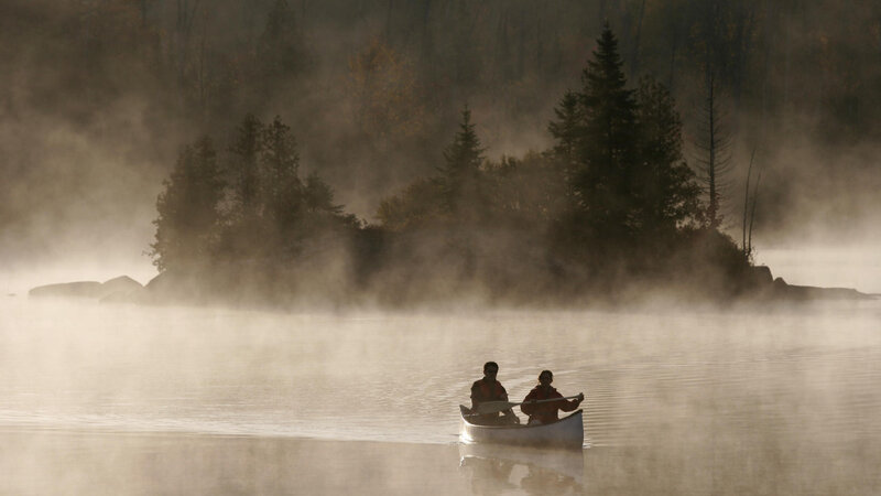 Canoeing on a misty lake