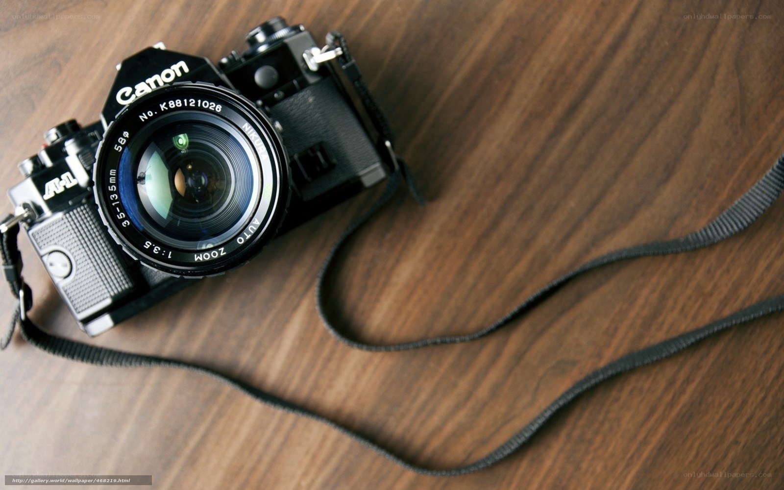 Canon camera on wooden surface