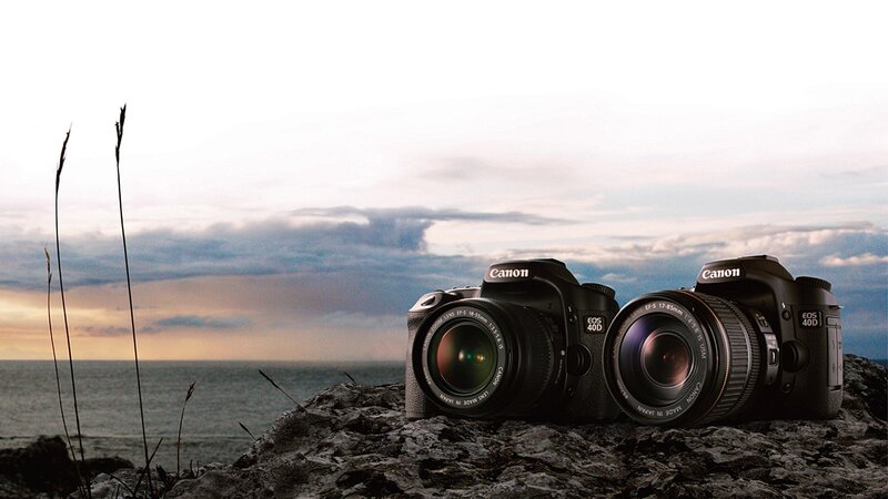 Canon cameras on a rocky shore