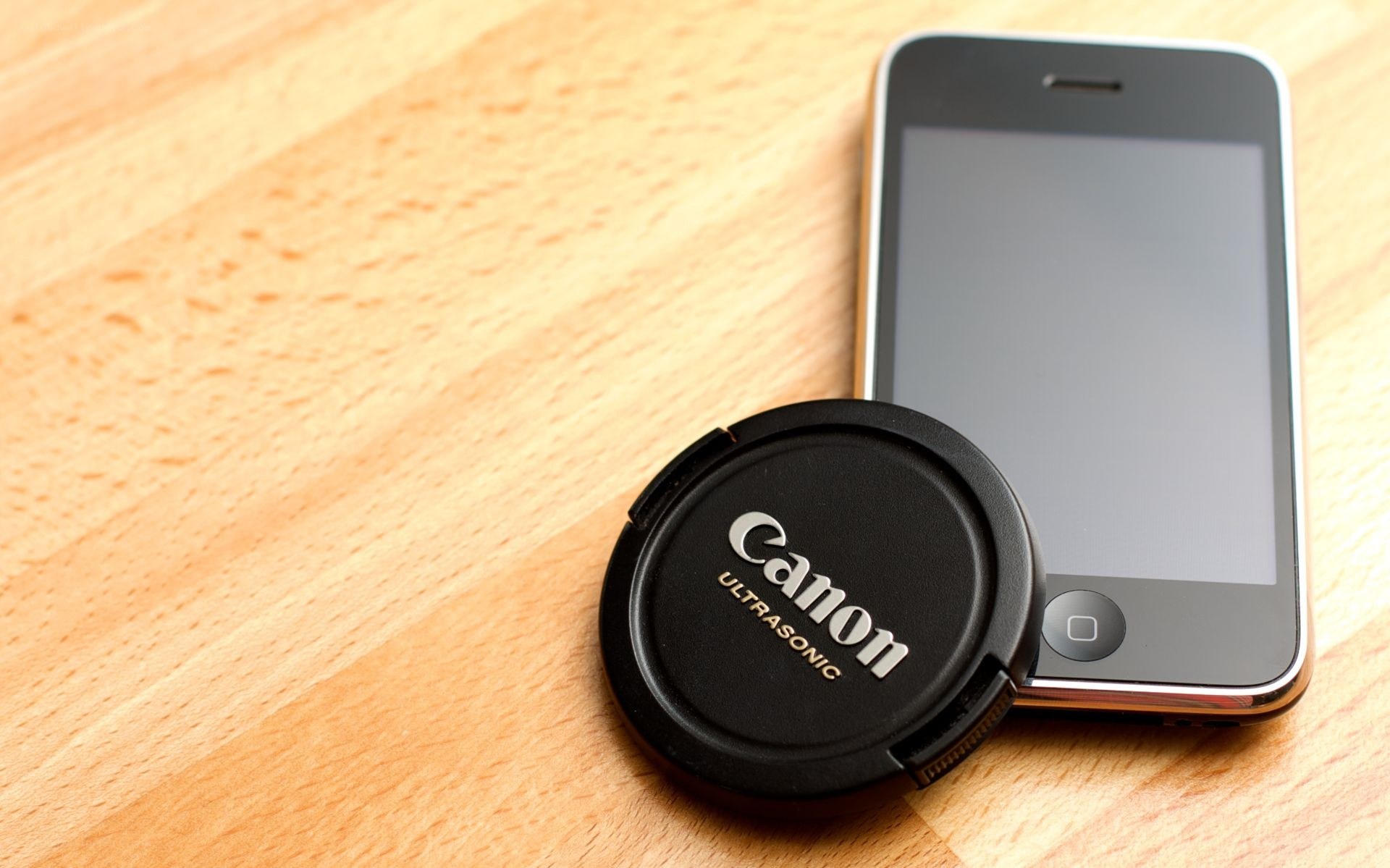 Canon lens cap and smartphone