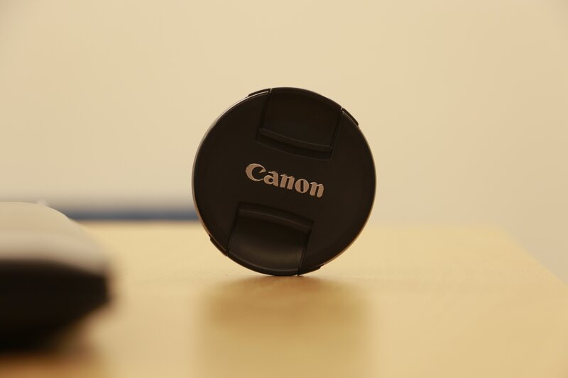 Canon lens cap on table