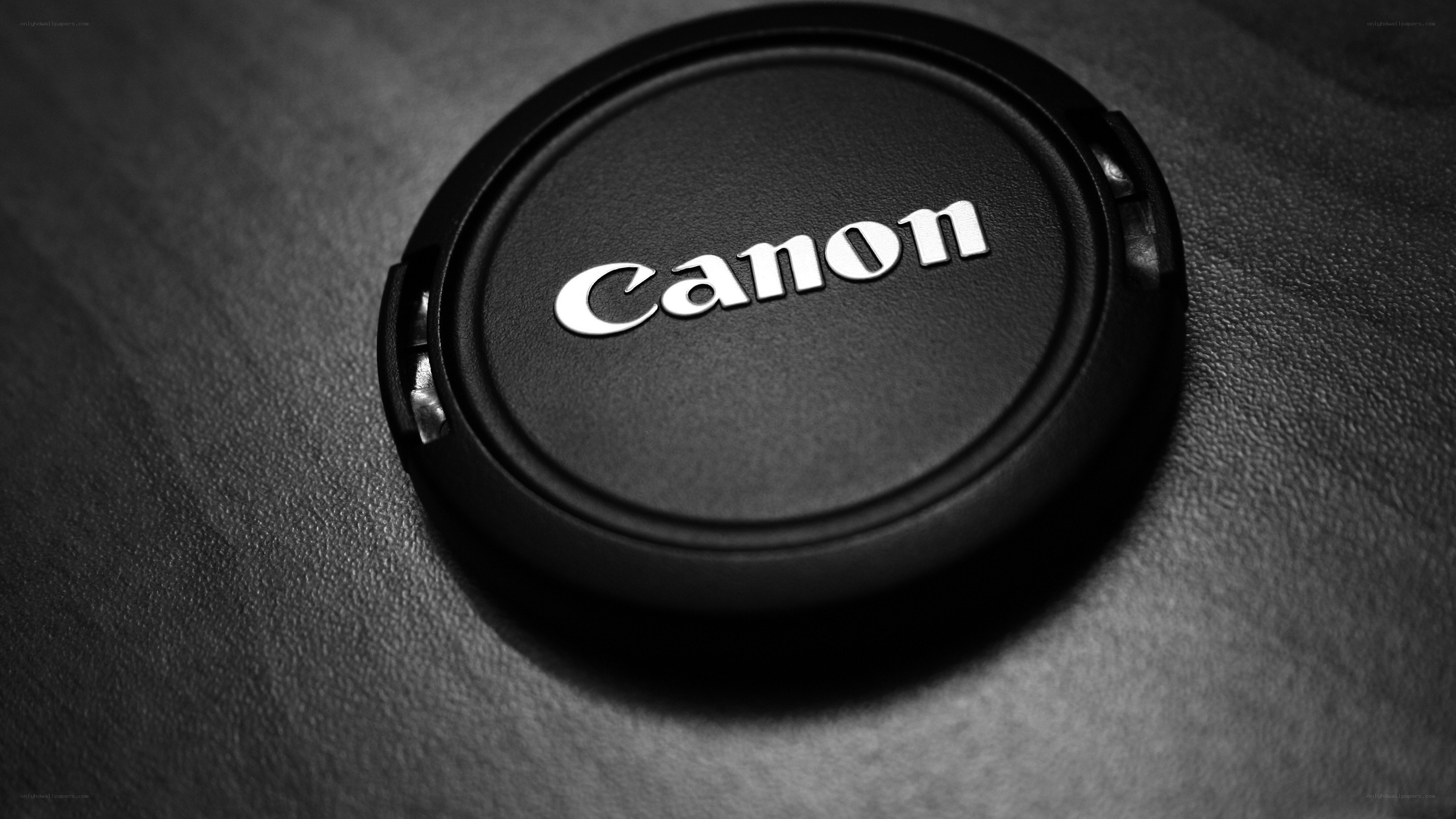 Canon lens cap on textured surface