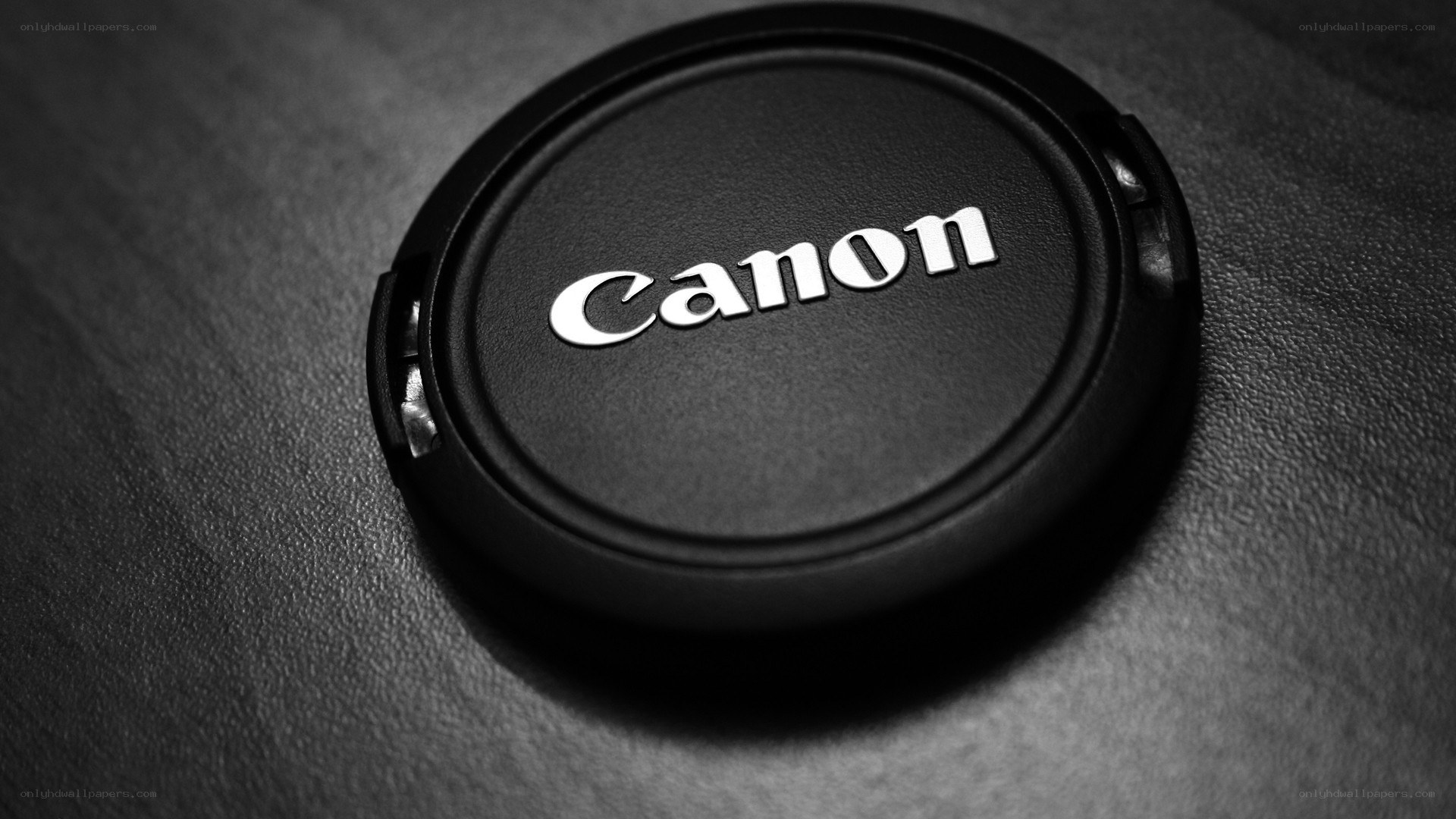Canon lens cap on textured surface