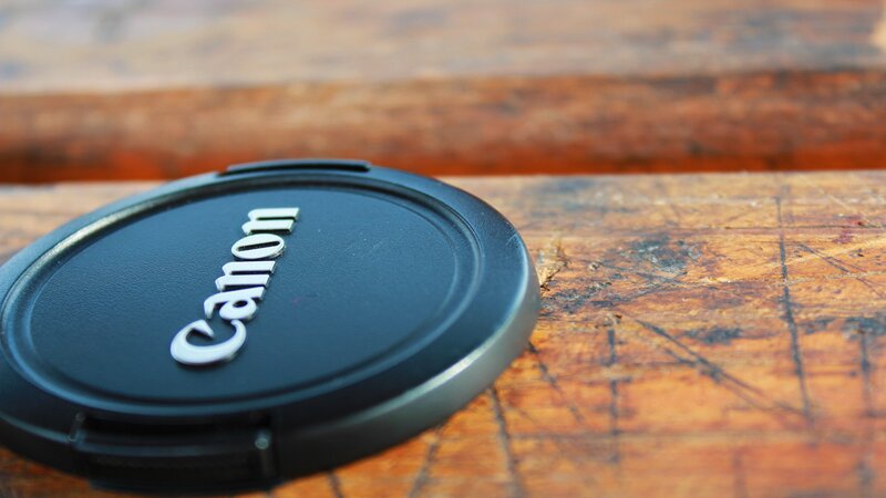 Canon lens cap on wood