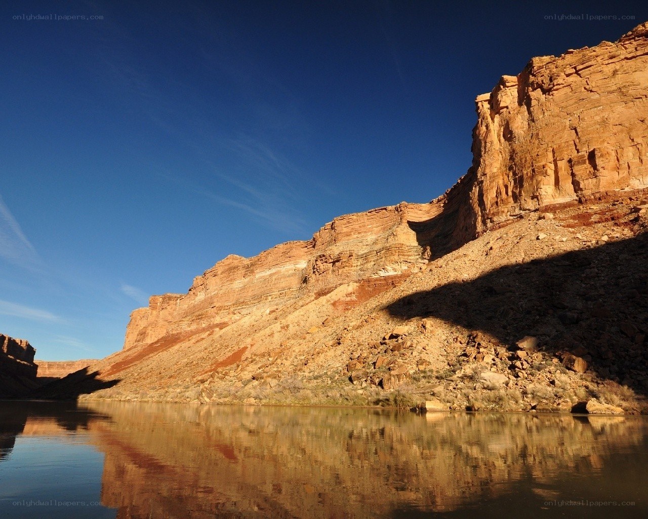 Canyon cliffs reflected in calm water