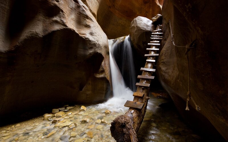 Canyon waterfall with wooden ladder