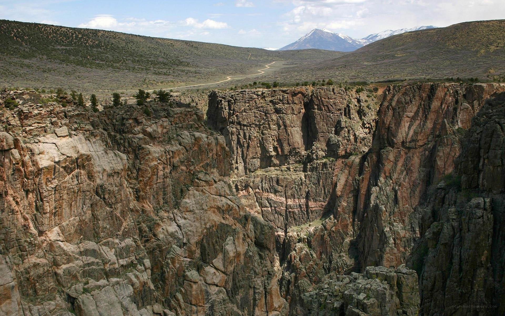Canyon with snow-capped mountains