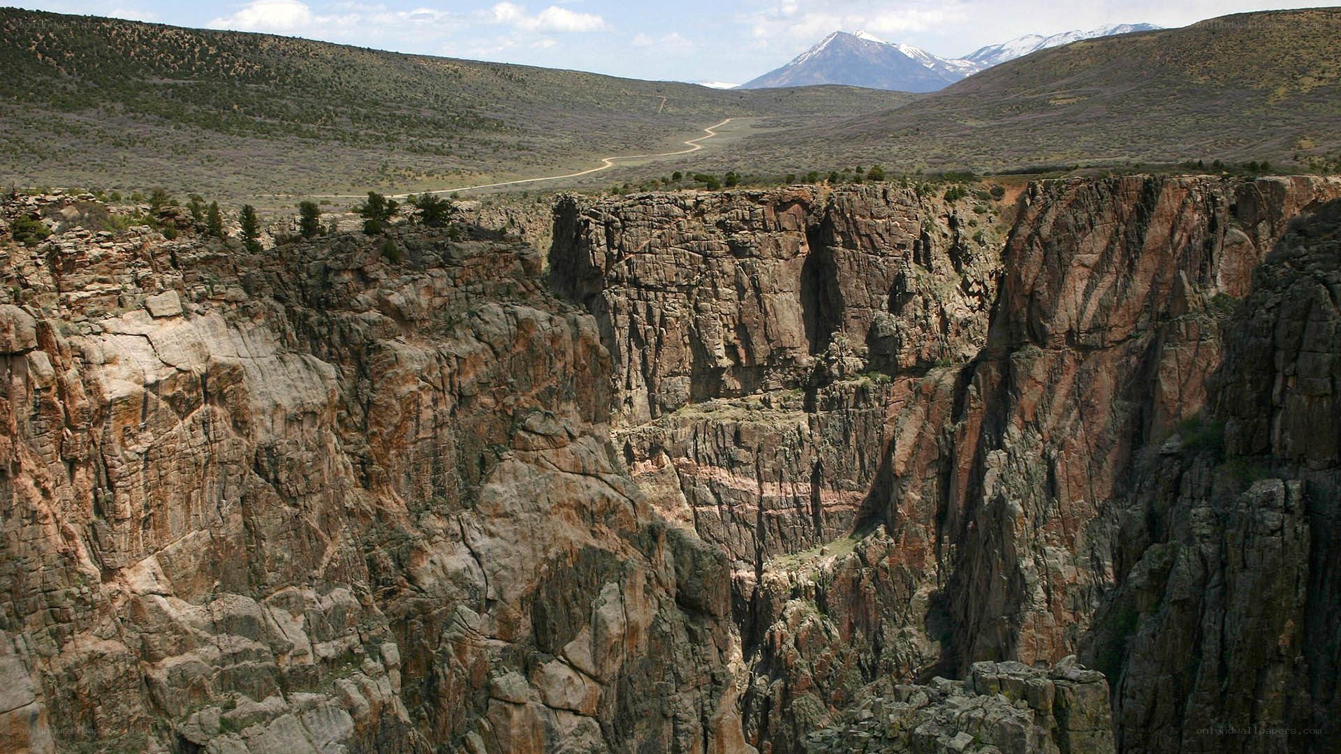 Canyon with snow-capped mountains