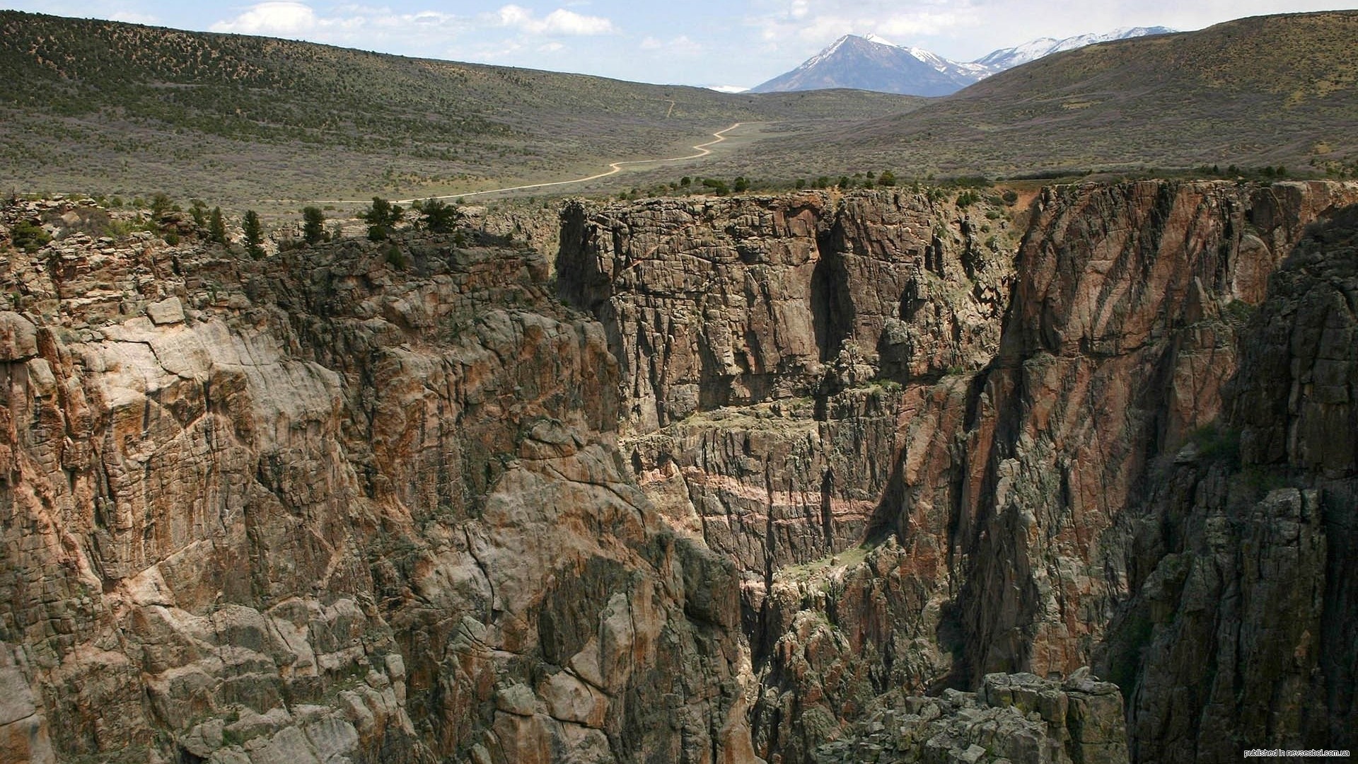 Canyon with snow-capped mountains