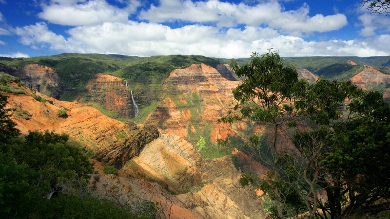 canyon with waterfall and green hills