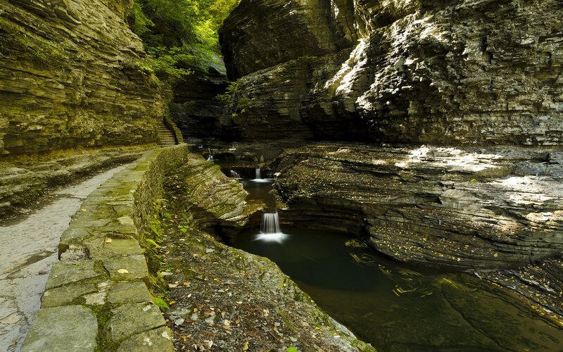 Canyon with waterfall and stone path