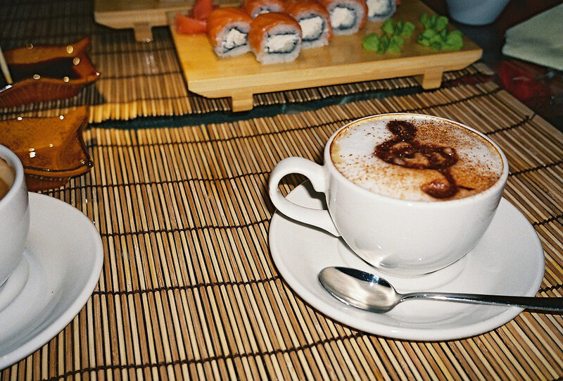 Cappuccino and sushi on a mat