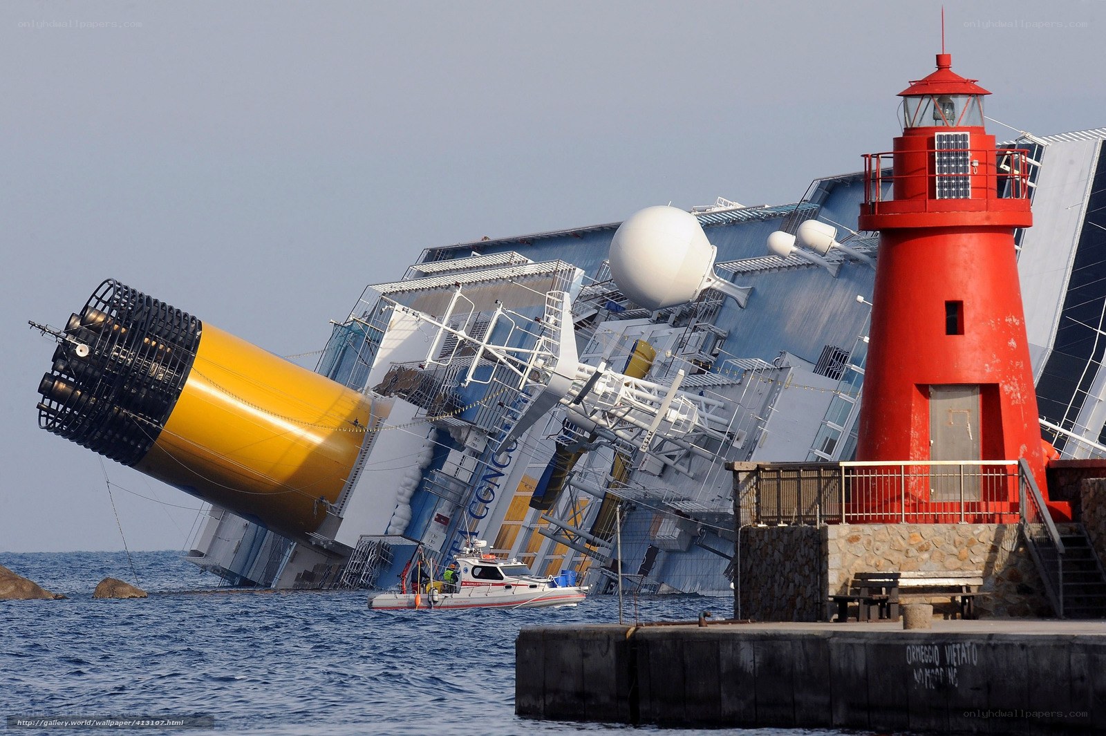 Capsized cruise ship near lighthouse