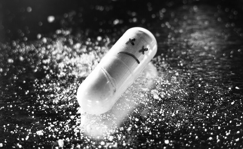 Capsule with Sad Face — Black