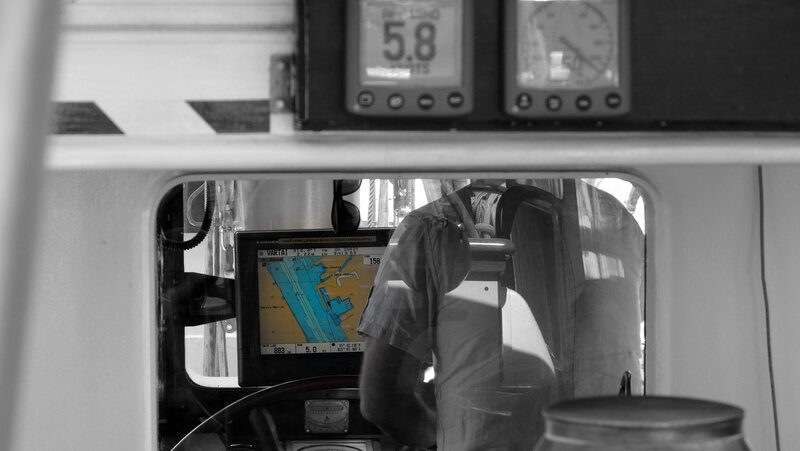 Captain at helm on boat