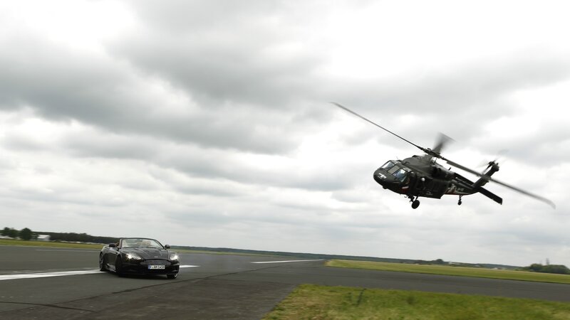 Car and helicopter on runway