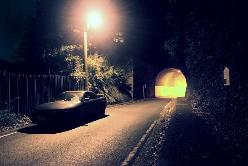 Car at night near tunnel
