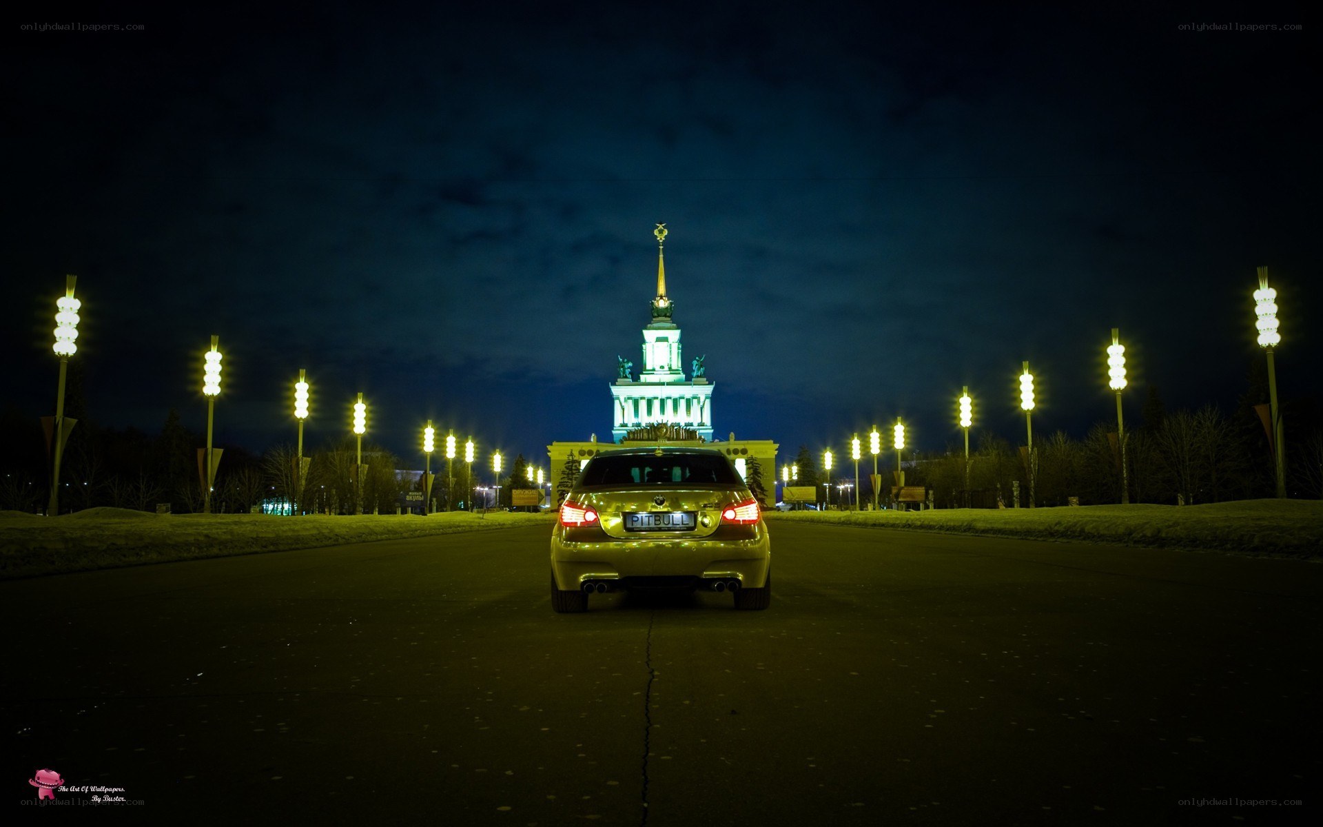Car at night with illuminated building