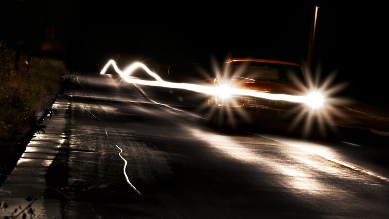 Car at night with light trails