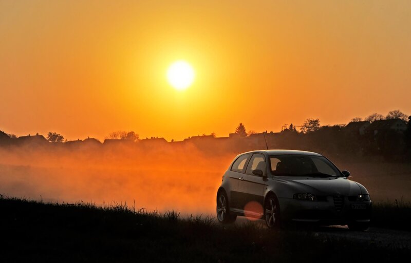 Car at sunrise with fog