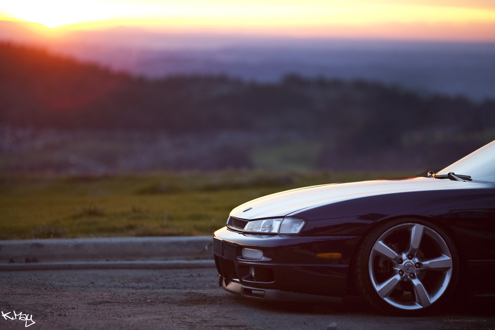 Car at sunset on a hill