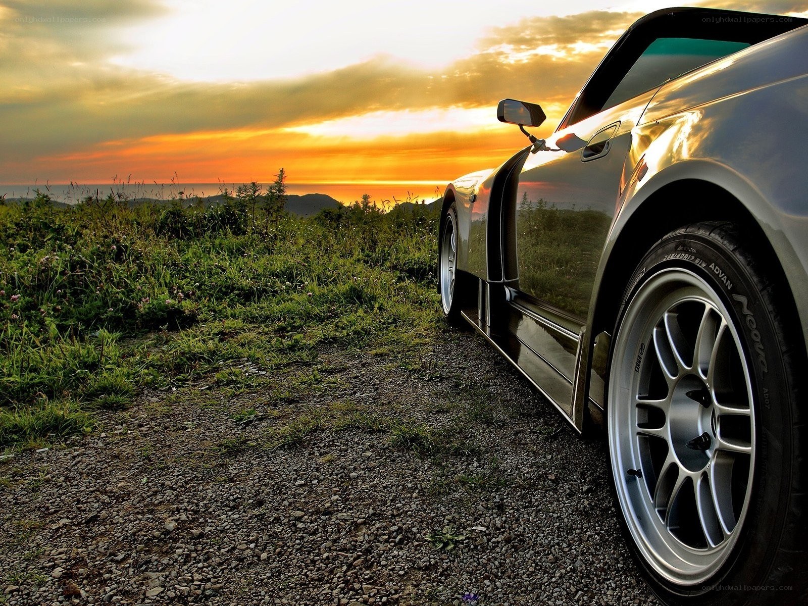 Car at sunset on a hill