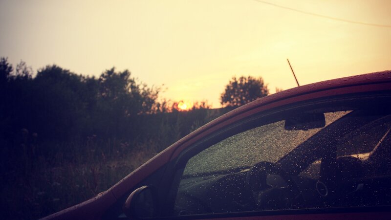 car at sunset with raindrops